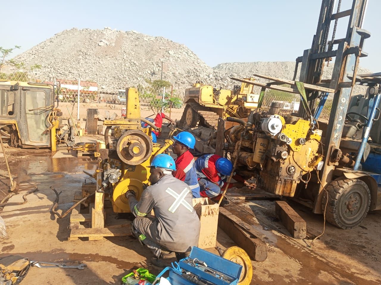 Subsurface technicians overhauling Caterpillar diesel engines mounted on stands in the yard